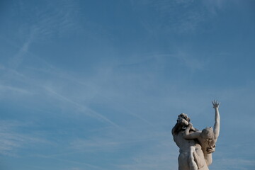 Blue sky and a mythical statue in the garden of Tuileries