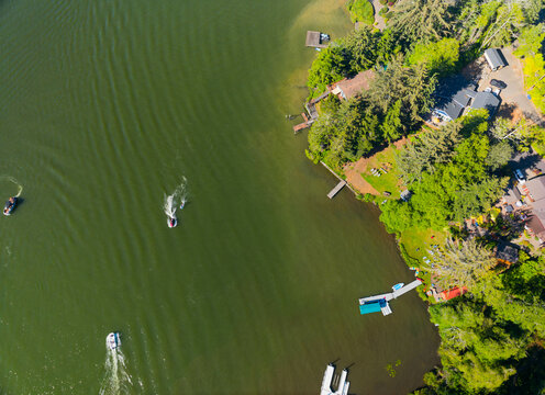A lake with a few boats on it and a house in the background