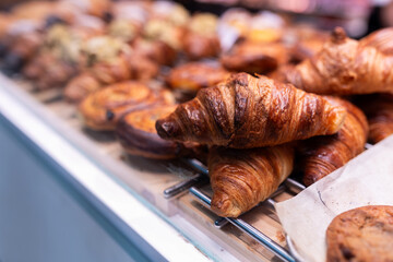 Close-up of a croissant and assorted pastries at a market stall