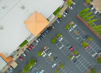 A parking lot with a lot of cars and a building in the background © Anton