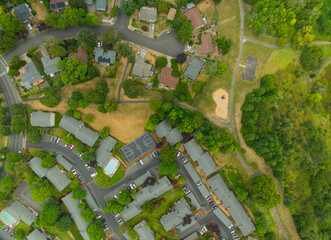 A view of a residential area with a few houses and a park