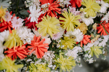 Wedding decoration flowers, a mix of real and artificial blooms, arranged elegantly