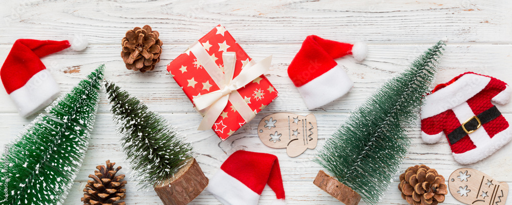 Wall mural flat lay composition with christmas trees on color background. top view with copy space