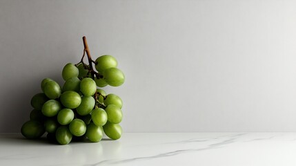 Green grapes bunch on marble surface.