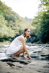 A Graceful Woman is Delightfully Enjoying the Serenity of Nature by the Beautiful Water