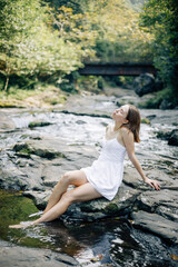 Fototapeta premium Serene and Tranquil Moments by the Reflective Water A Beautiful Woman Embracing Nature