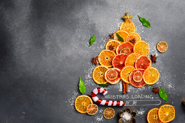 Abstraction of a Christmas tree made of citrus fruits. Top view. Christmas card with the...