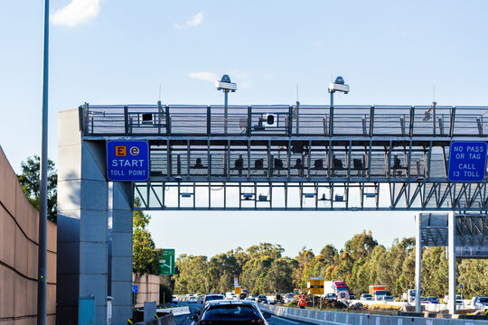 E-tag toll road start sign above highway with licence plate cameras