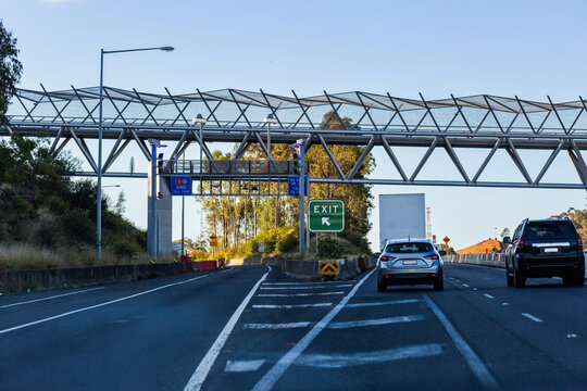 Drivers point of view on toll road with exit and end toll point signs