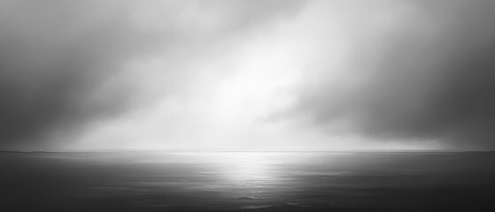 Fototapeta premium Serene black-and-white seascape with dramatic clouds.