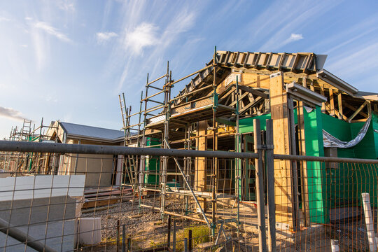new homes under construction in the afternoon light