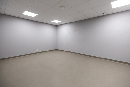 Empty Room with Gray Walls and White Acoustic Tile Ceiling