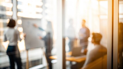 Teamwork Blur: A blurry view of an office team collaborating behind a glass partition.
