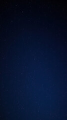 Fototapeta premium Dark night sky with numerous stars scattered across the canvas of a deep blue background, cosmos, shimmering