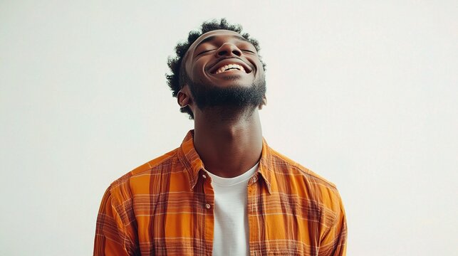 Happy Dark-Skinned Male Smiling in Horizontal Shot with Bright Background