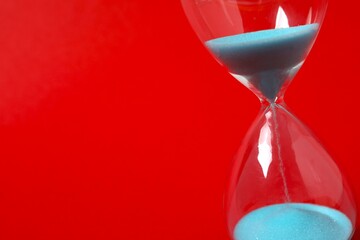 Modern hourglass on black background. Hourglass time concept for business deadline, urgency and...