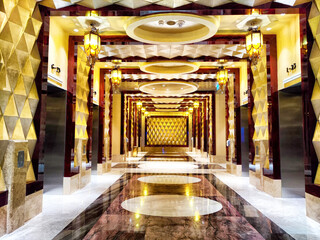Elegant hallway with geometric design and gold accents in a luxury building at night