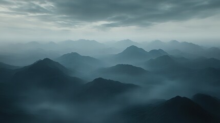 Fototapeta premium Aerial View of Mysterious Mountains Draped in Low Clouds with Dramatic Lighting Effects Creating an Enigmatic and Dreamlike Atmosphere.