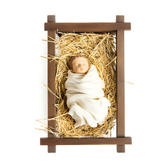 simple manger with baby Jesus wrapped in swaddling clothes, lying peacefully on straw. wooden manger is rustic and traditional, symbolizing nativity scene