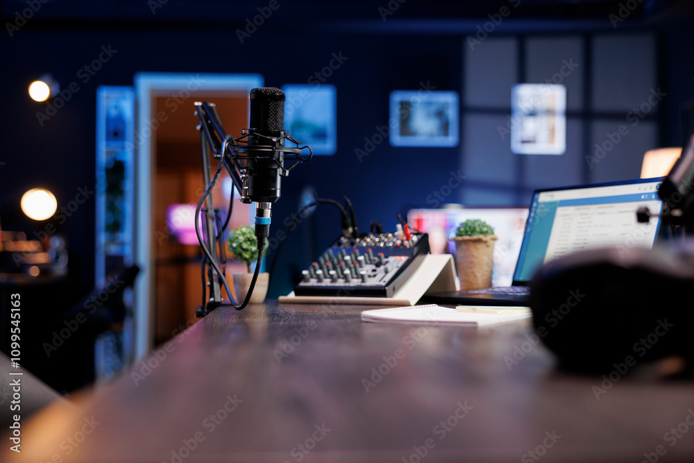 Poster vacant podcast home studio with a microphone boom arm, laptop, and a professional audio recording mi