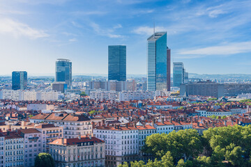 Modern skyscrapers rise over traditional buildings in la Part-Dieu district in Lyon, France, on a...