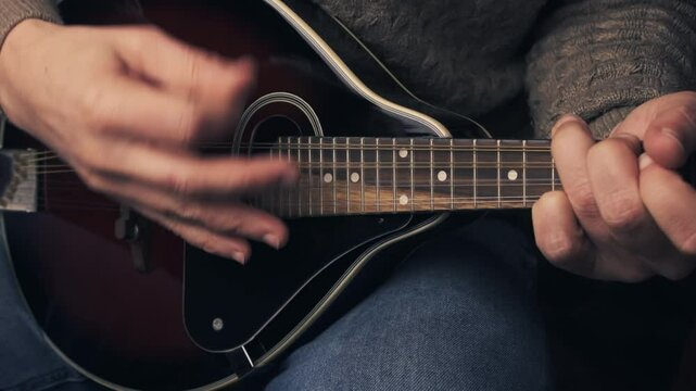 Close up of musician playing mandolin