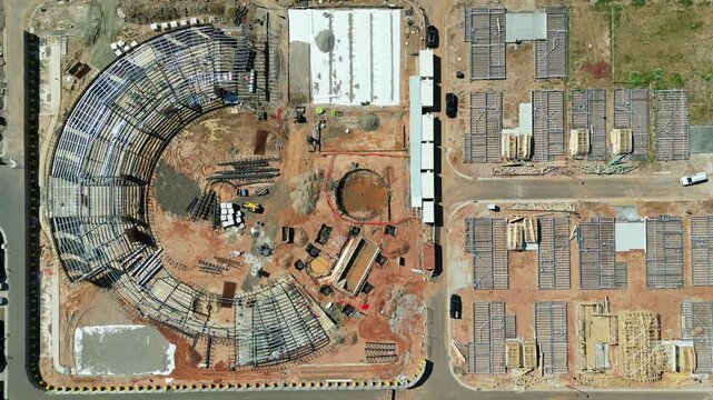 Aerial view of urban development at a construction site with modern buildings and infrastructure, Clyde North, Australia.