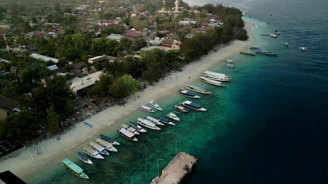 Aerial view of Gilli Trawangan with boats on the turquoise sea and sandy beach, Bali, Indonesia.