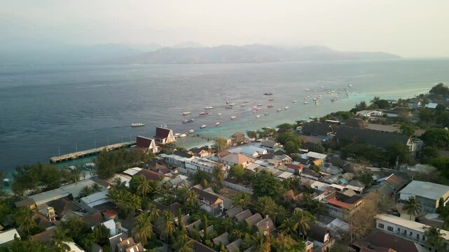 Aerial view of the tropical paradise island of Gilli Trawangan with serene waters and boats at sea, Bali, Indonesia.