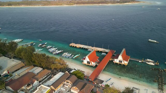 Aerial view of boats on the turquoise sea near the beach and dock, Gilli Trawangan, Indonesia.