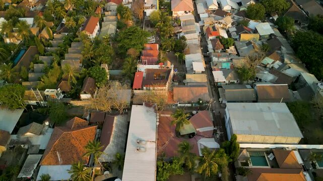 Aerial view of beautiful Gilli Trawangan with vibrant homes, tranquil beach, and clear water, Bali, Indonesia.