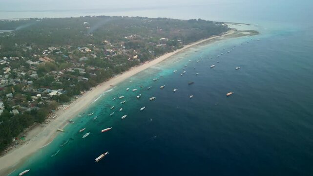 Aerial view of beautiful Gilli Trawangan with boats on the turquoise sea, Bali, Indonesia.