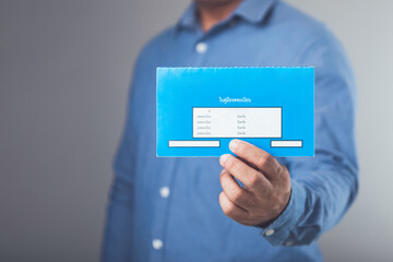 Businessman holds Thailand's blue vehicle registration book, issued after full loan repayment,...