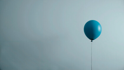 Obraz premium Minimalist design with solitary blue balloon floating against gray background and diffused lighting, symbolizing Blue Monday