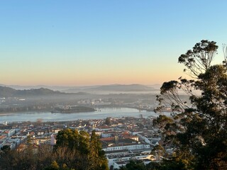 View of the Viana do Castelo city and the Lima river from the Santa Luzia mountain during sunset, Portugal, January 2024