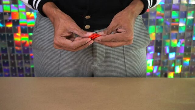 Man putting together two building blocks with keychains to make heart