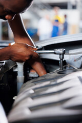 Engineer expertly examines steering mechanism using advanced mechanical tools, ensuring optimal...
