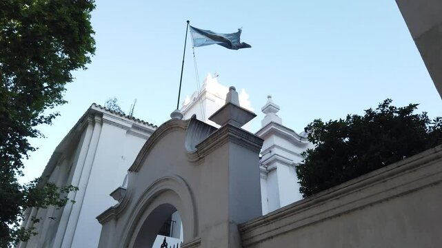 Cabildo colonial building with Argentine flag waving in spring skyline Low Angle