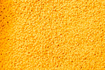 Masterbatch granules on a white background, this polymer is a colorant for products in the plastics...