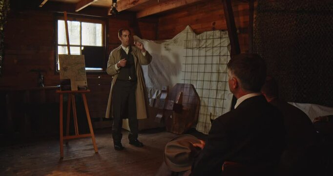 A secret agent shows a little capsule during a covert mission briefing