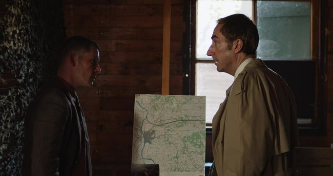 World War 2 era concept - A squad leader deliberates with a spy on a mission briefing