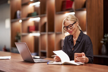 A Professional Woman Actively Engaged in Her Work at a Stylish Modern Desk Environment