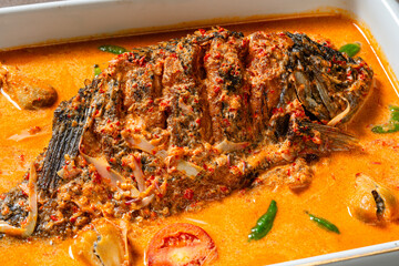 Fried Gourami cooked in spicy sour curry with asam cikala