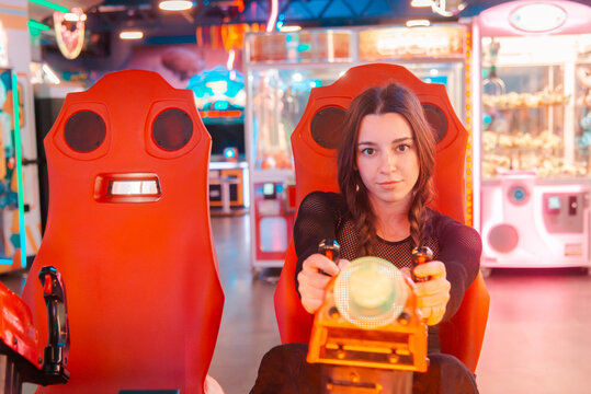 Gamer girl enjoying an arcade machine experience