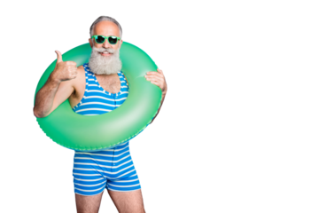 Portrait of cheerful grandfather in eyewear eyeglasses showing approval sign wearing striped bathing suit isolated over blue background