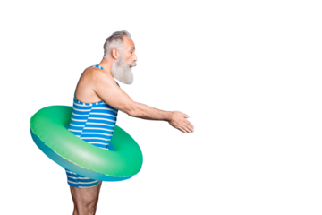 Profile side photo of attractive old man jumping holding lifesaver wearing striped bathing suit isolated over blue background