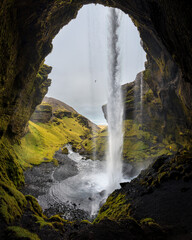 Kvernufoss is a beautiful waterfall hidden in a small gorge near Skogar in Iceland. View from the cave behind the waterfall.