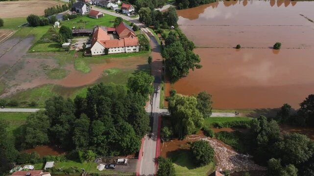 Aerial view of flooded village Humme with submerged homes and greenery, Hofgeismar, Germany.