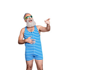 Portrait of nice attractive funky cheerful cheery glad gray-haired man pointing at funny thing news...