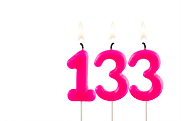 Pink number 132 birthday candle lit on white background